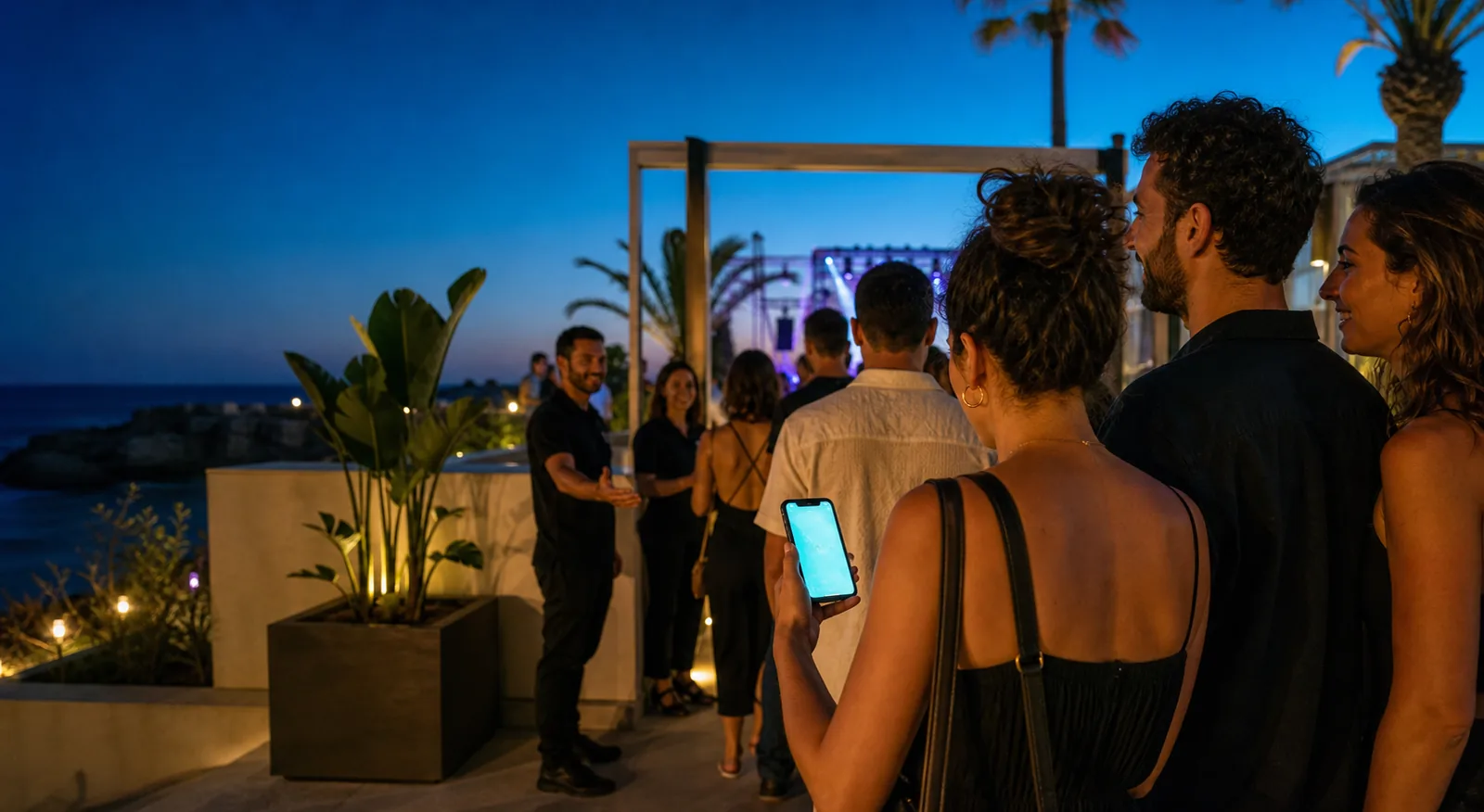Friends arriving at a seaside event with a digital ticket ready on a smartphone
